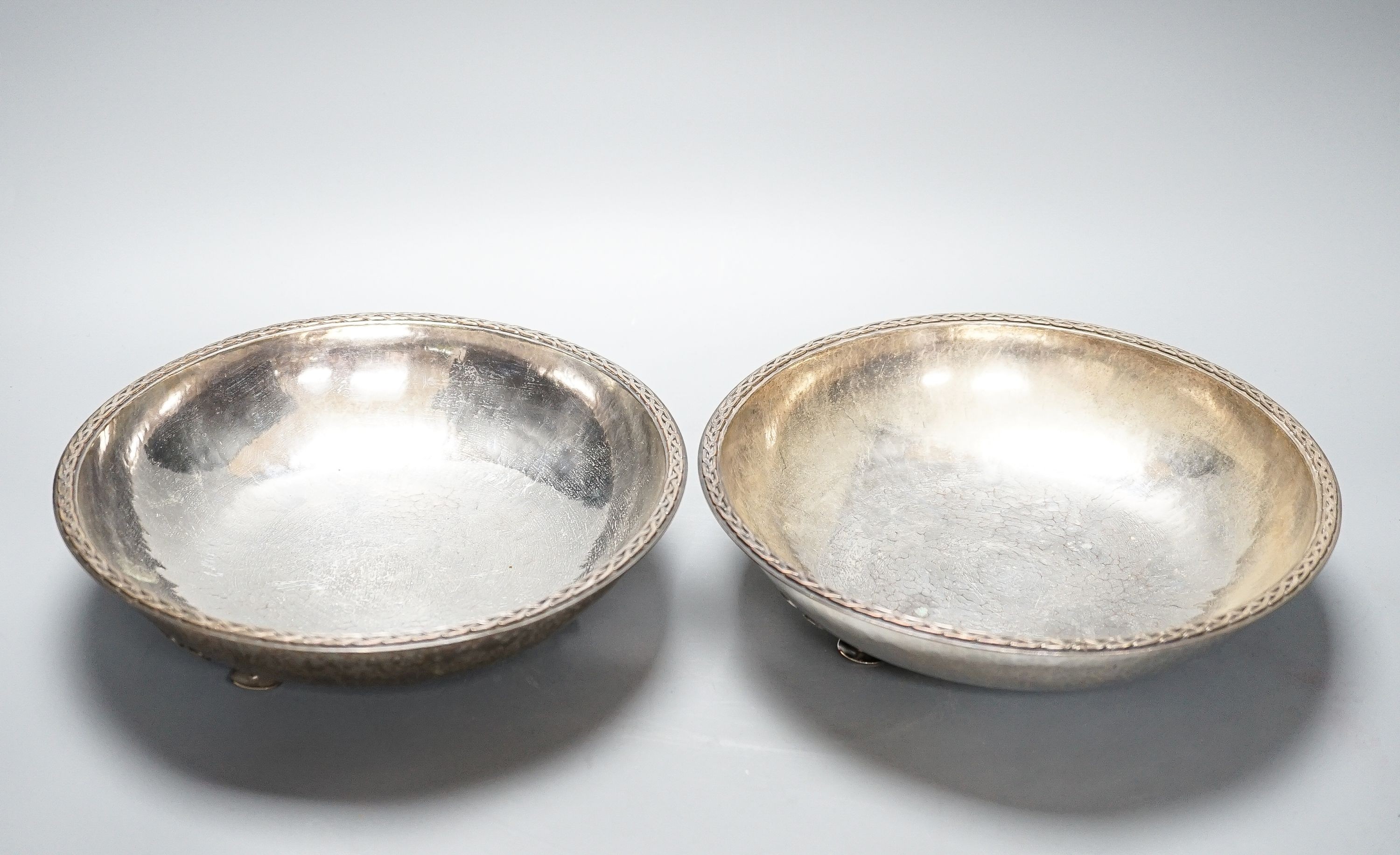 A pair of Keswick School of Industrial Arts silver plated bowls, on stylised spade feet, 23cm diameter